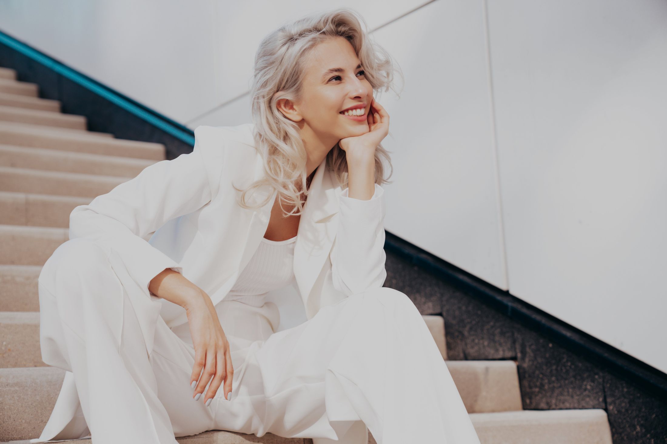 Smiling woman with long blonde hair.